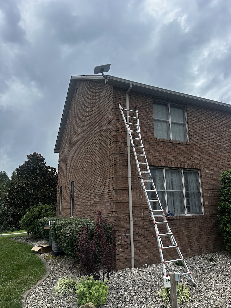 Starlink dish mounted above the roofline of a two-story brick home